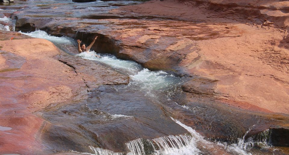 Andrew sliding down the slides of Slide Rock State Park in Arizona. Weeee!